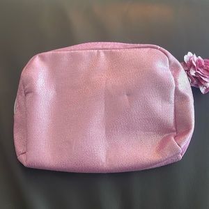 Lancôme shimmering pink make up bag with flower tassel zipper.